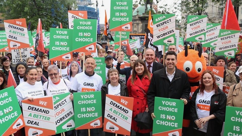 Workers march in Leeds against a new contract by supermarket giant Asda