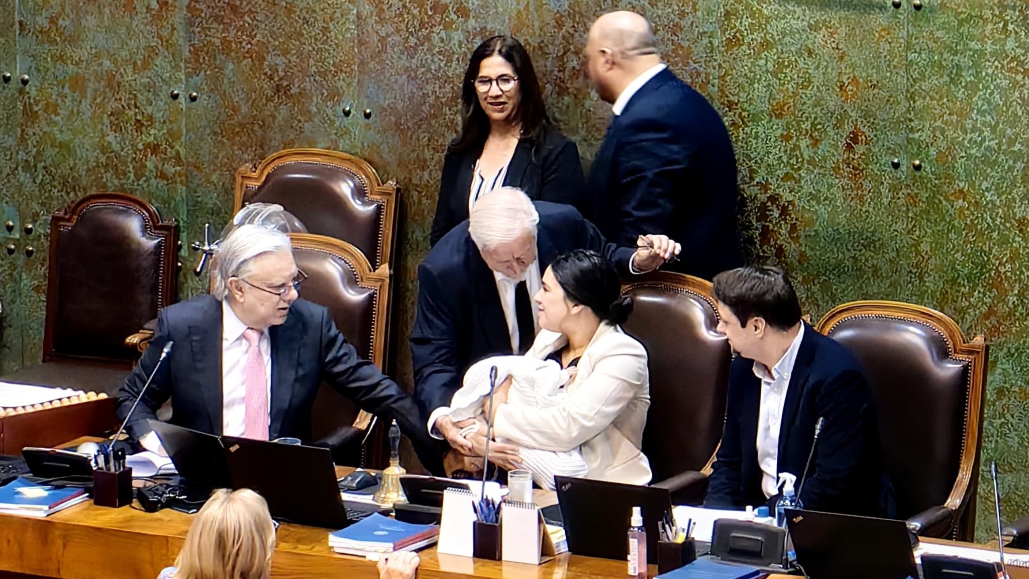 Communist legislator defies right-wing censure attempt with days-old newborn in her arms