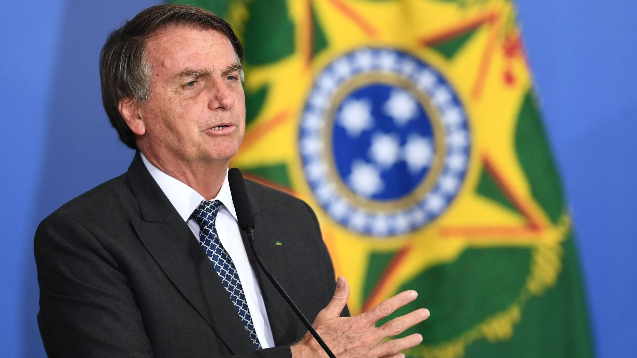 Jair Bolsonaro in front of flag