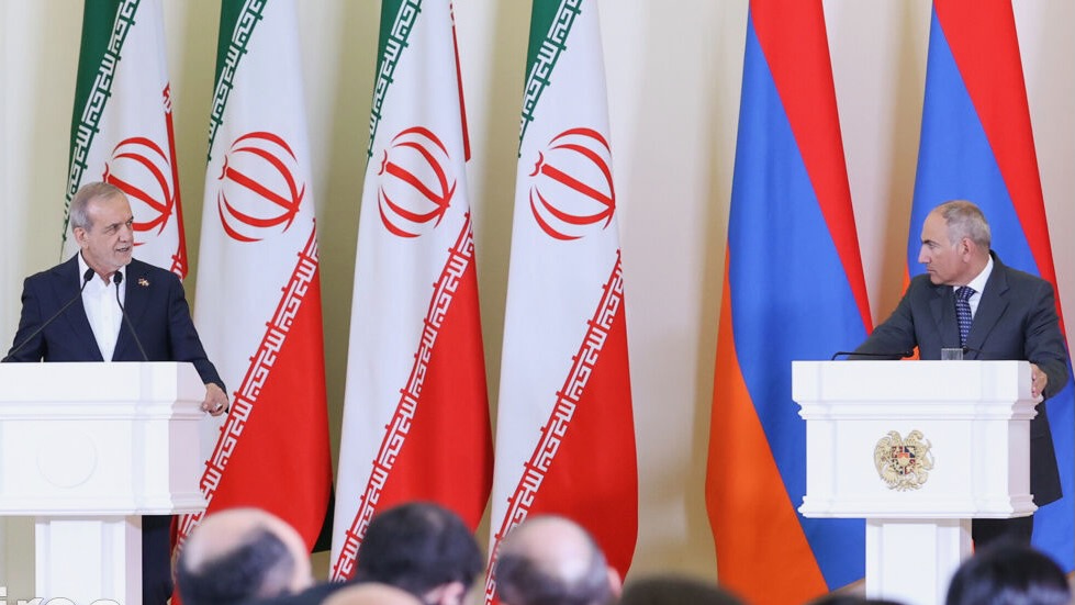 Iranian President and Armenian PM in front of Iranian and Armenian flags