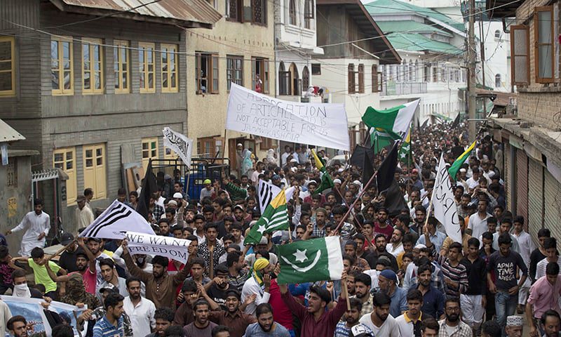 Protesters shout slogans and march on a street after Friday prayers in Srinagar. (Photo: Dar Yasin)