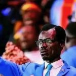 Patrice Lumumba look-alike at AFCON stands motionless in the stands