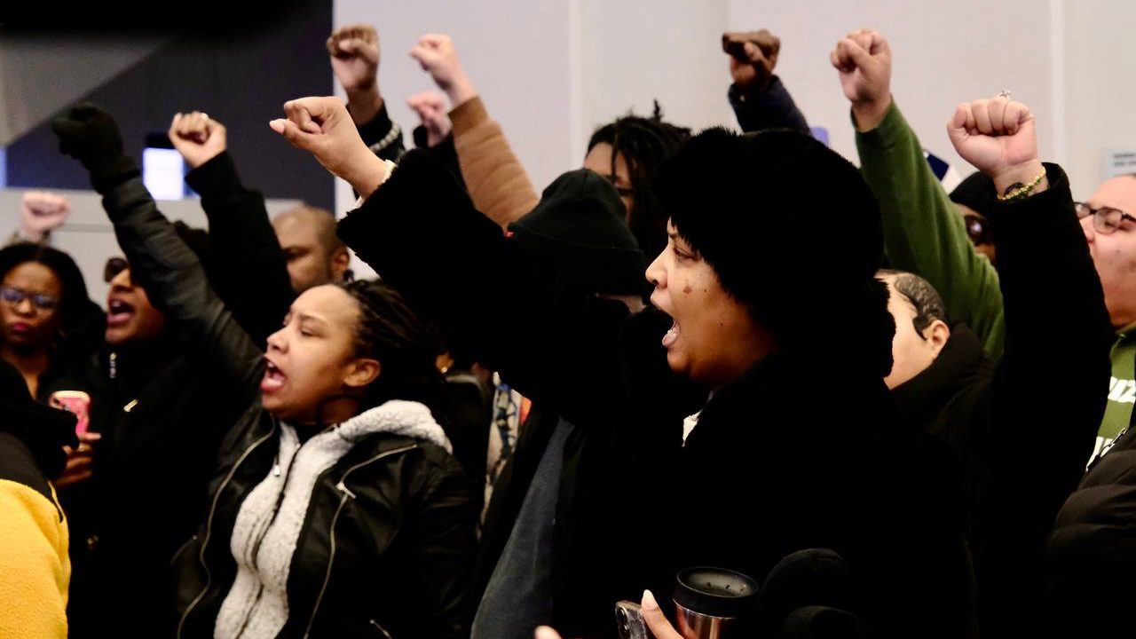 Fists raised during press conference demanding the release of detained activists