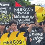 Youth protestors in Philippines raise signs against corruption