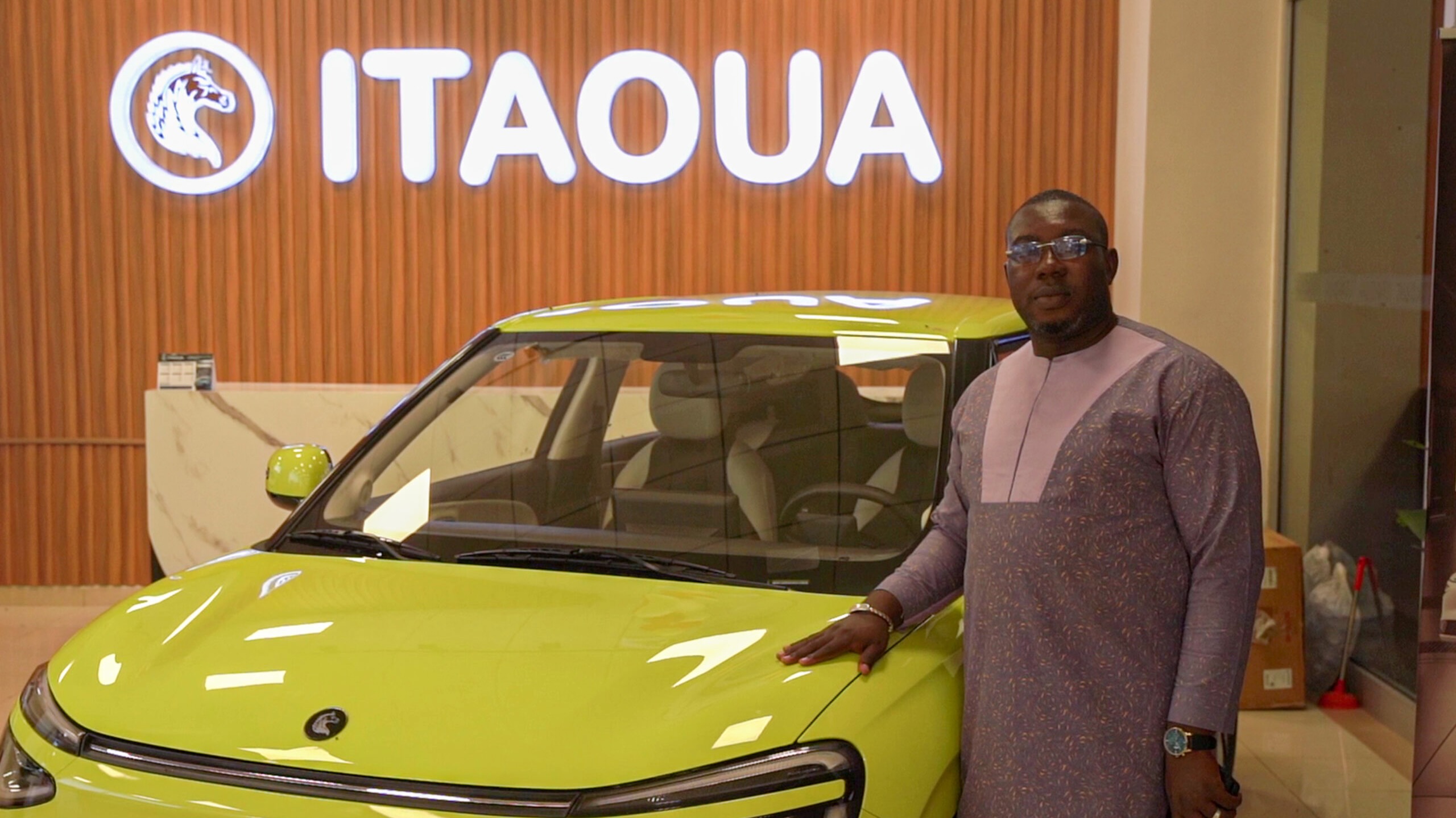 Man poses with 100% electric car made in Burkina Faso