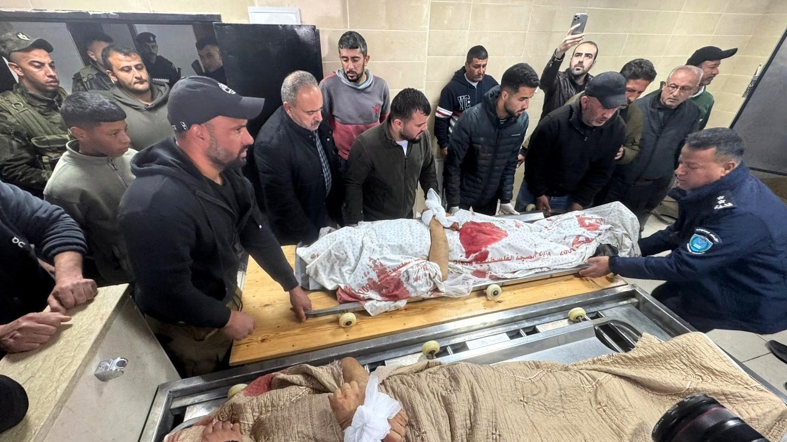 The bodies of the two martyred brothers, Muhammad and Fahim Muammar, arrived at Rafidia Hospital in Nablus (1)