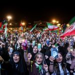 Protestors wave Iranian flags