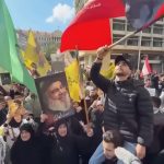 Protesters raise Lebanese flags in Beirut