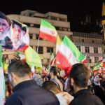 Protestors in Tehran wave Iranian flags