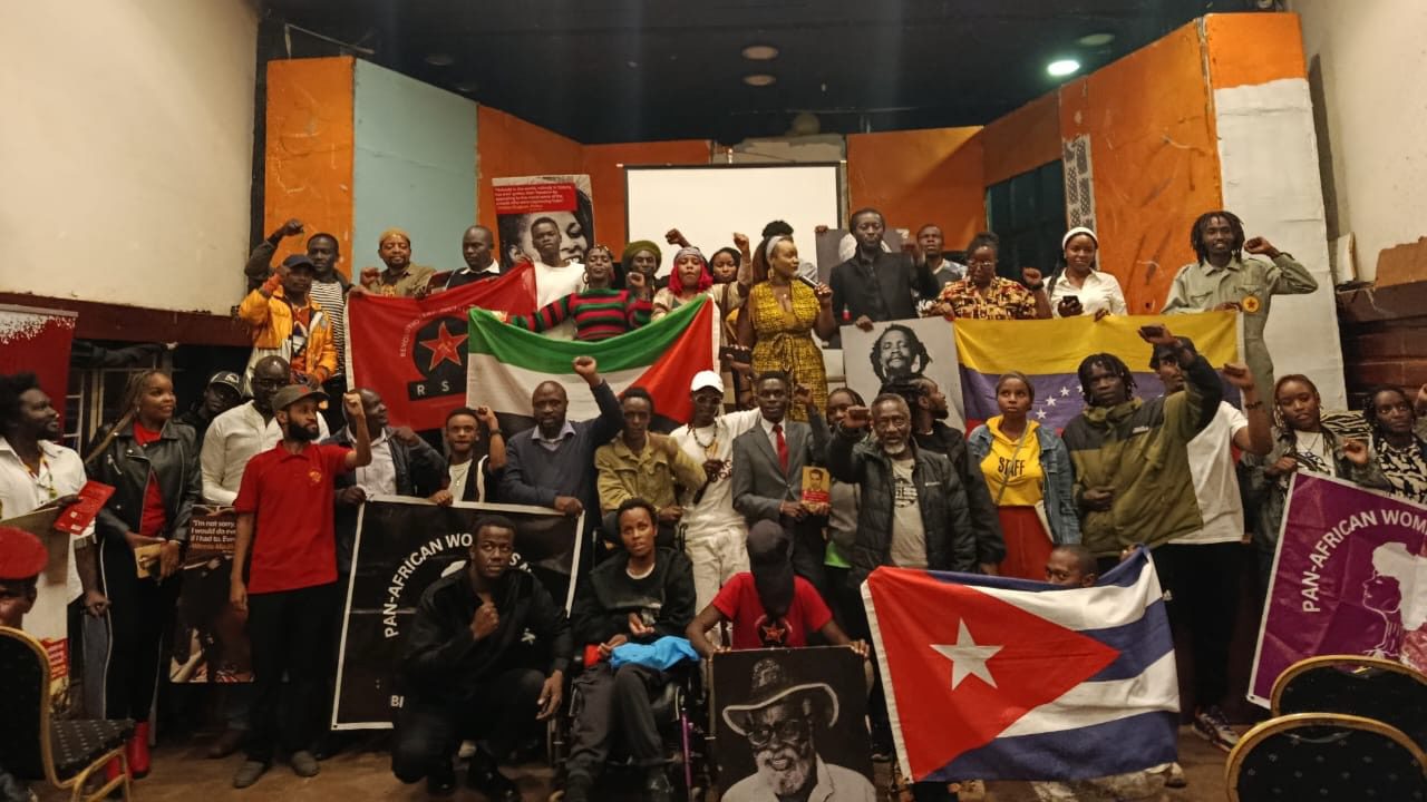 Kenyan socialists and leftists raise international revolutionary flags during a forum for African Liberation Day