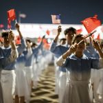 Chinese youth wave Chinese and US flags