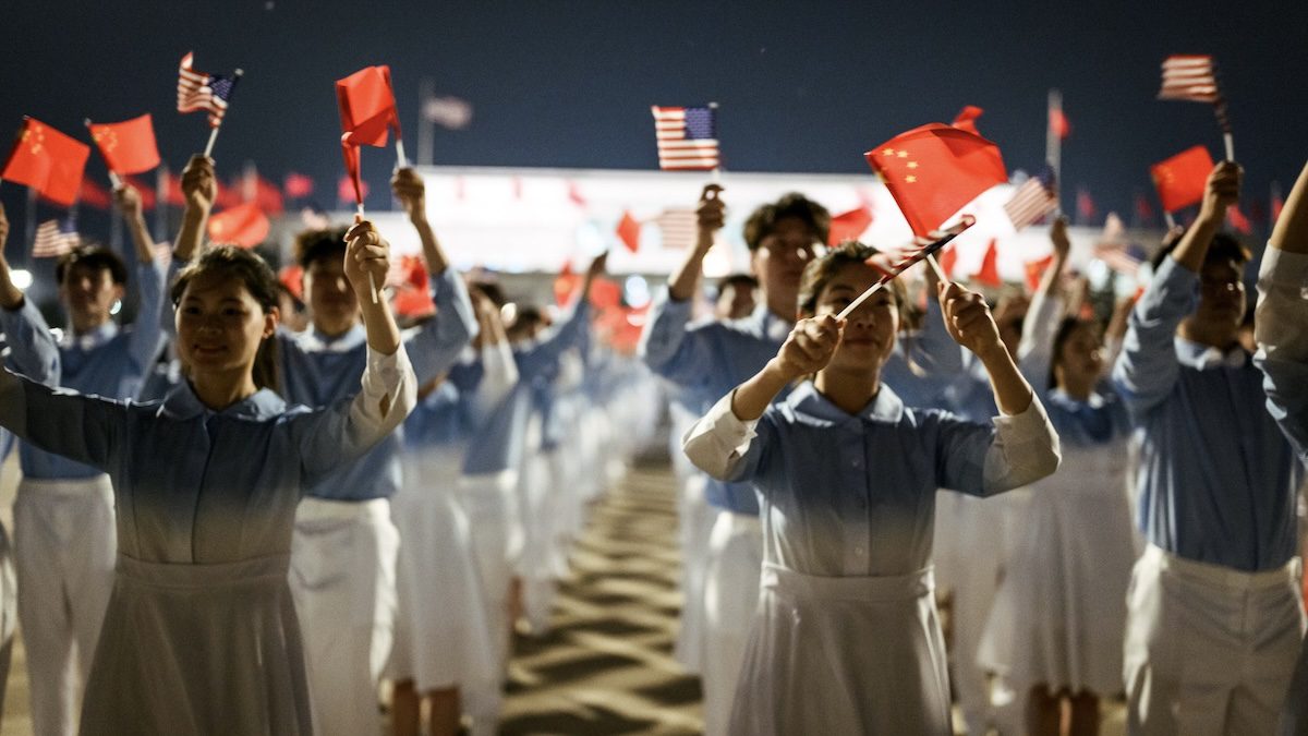 Chinese youth wave Chinese and US flags