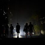 Cubans walk in the dark during blackout in Havana