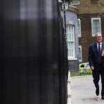 Prime Minister Keir Starmer walking on sidewalk
