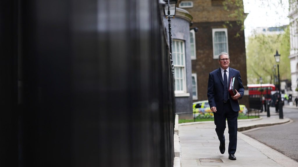 Prime Minister Keir Starmer walking on sidewalk