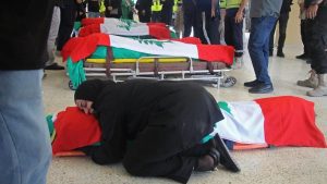 Lebanese woman hugs family member killed by Israeli airstrikes