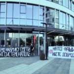 Protesters hold banners against Elbit Systems in Serbia
