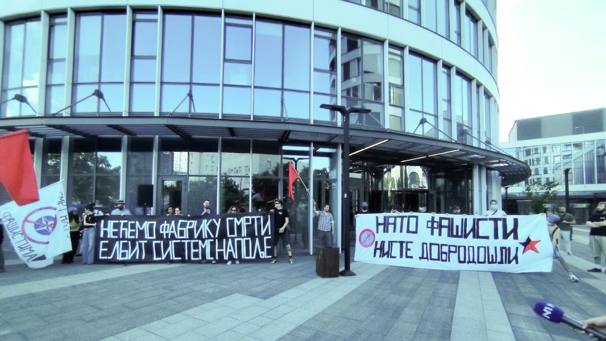 Protesters hold banners against Elbit Systems in Serbia