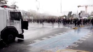 Water cannon blasts group of students