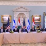 Delegates from the US, Israel, and Lebanon sit at a table for negotiations