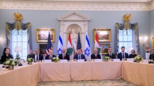 Delegates from the US, Israel, and Lebanon sit at a table for negotiations