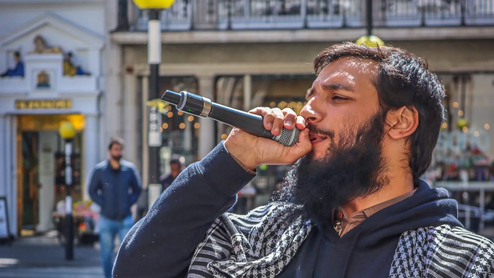 Umer Khalid speaking into a mic