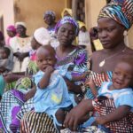 Dorcas Simon 38-year-old plays with her twin daughters