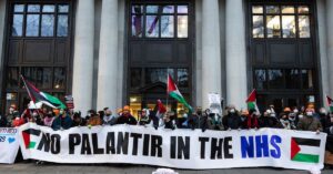 Activists raise banner that reads "No Palantir in the NHS!"