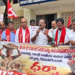 Group of Indian leftists hold red flags and banner for the right to work