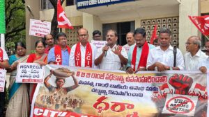 Group of Indian leftists hold red flags and banner for the right to work