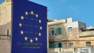 Art piece of EU symbol with barbed wire between the stars and a quote