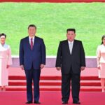 Xi Jinping, general secretary of the Communist Party of China Central Committee and Chinese president stands next to Kim Jong Un, general secretary of the Workers' Party of Korea